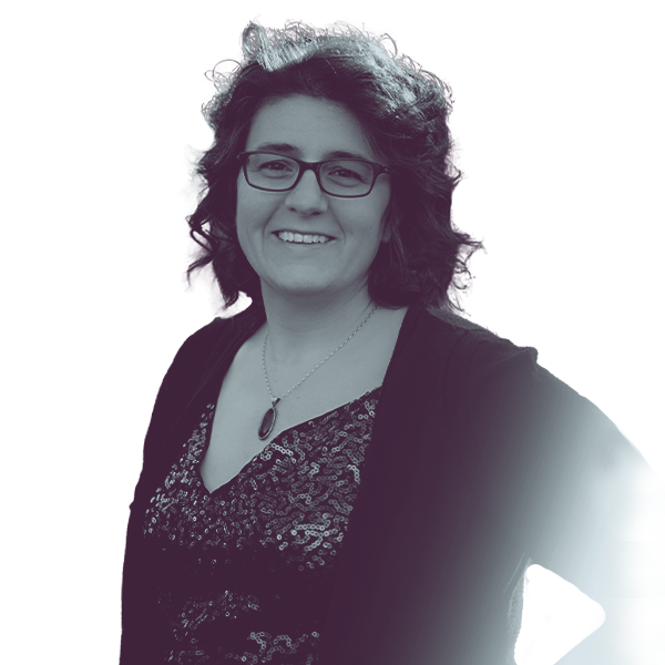 B&W image of Bianca Virnig from the waist up, smiling and looking into the camera.