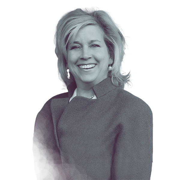 A black and white portrait of Elizabeth Moro of PA HD-160 from the waist up, smiling and looking into the camera.