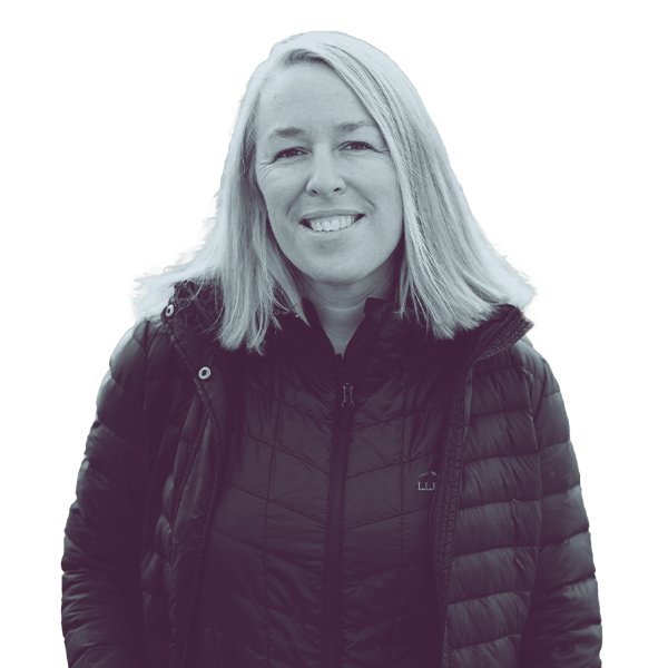 A black and white portrait of Mandy Steele of PA HD-33 from the waist up, smiling and looking into the camera.