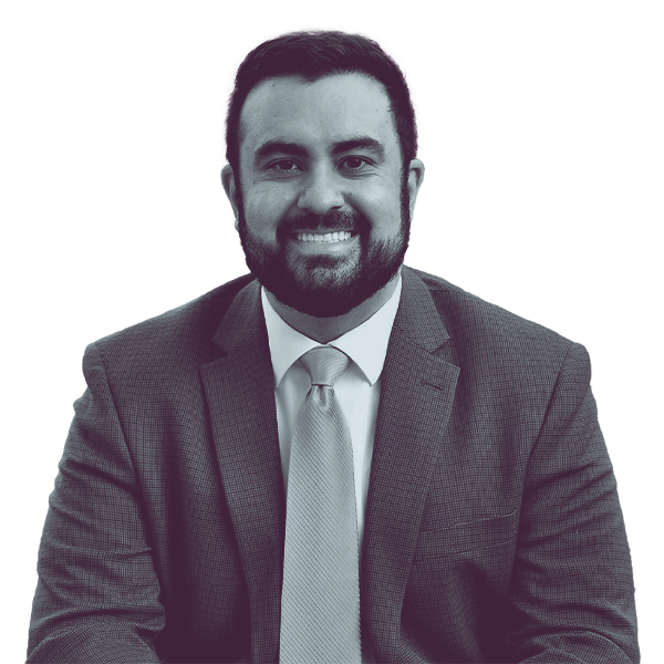 A black and white portrait of Nick Pisciottano of PA SD-45 from the waist up, smiling and looking into the camera.