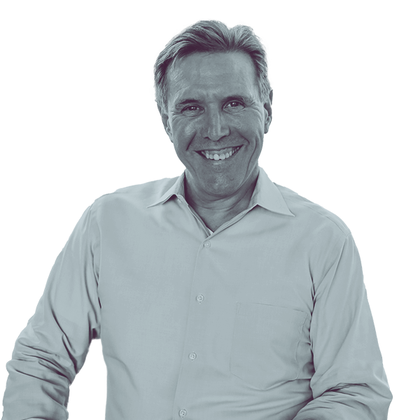 A black and white portrait of Paul Takac of PA HD-82 from the waist up, smiling and looking into the camera.