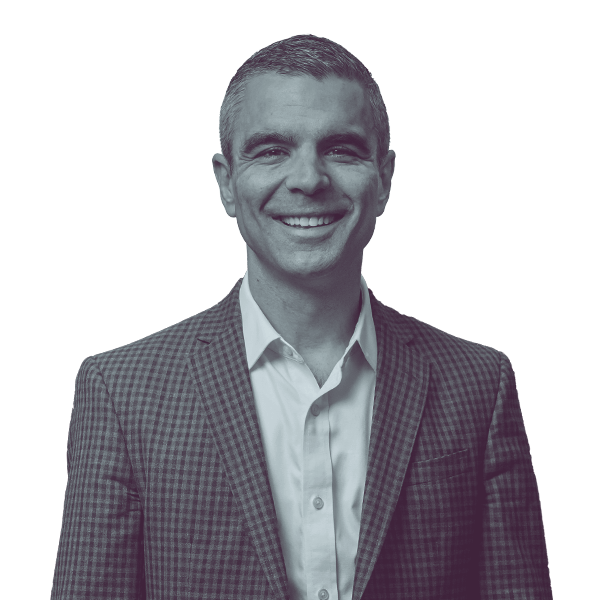 A black and white portrait of Anthony Broadman of Oregon Senate District 27 from the waist up, smiling and looking into the camera