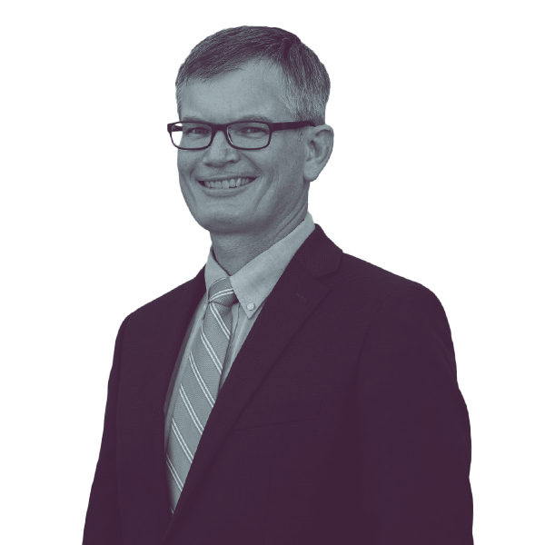 A black and white portrait of Eric Giddens of Iowa Senate District 38 from the waist up, smiling and looking into the camera.