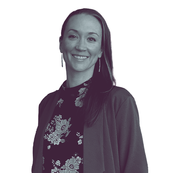 A black and white portrait of Heather Sievers of Iowa House District 40 from the waist up, smiling and looking into the camera.
