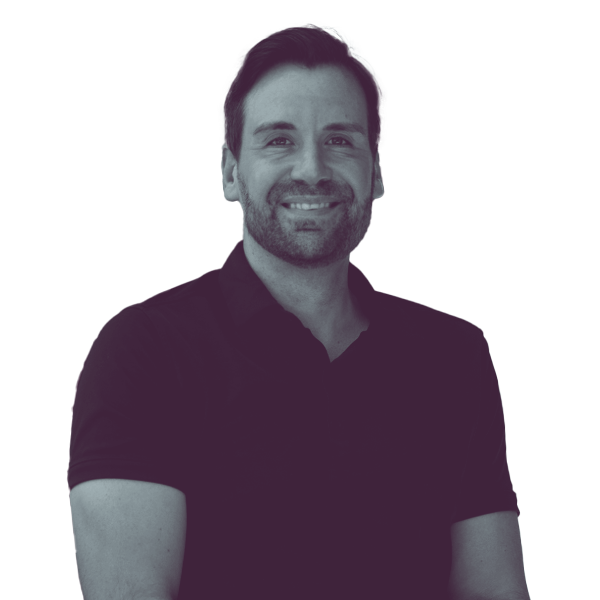 A black and white portrait of Josh Turek of Iowa House District 20 from the waist up, smiling and looking into the camera.