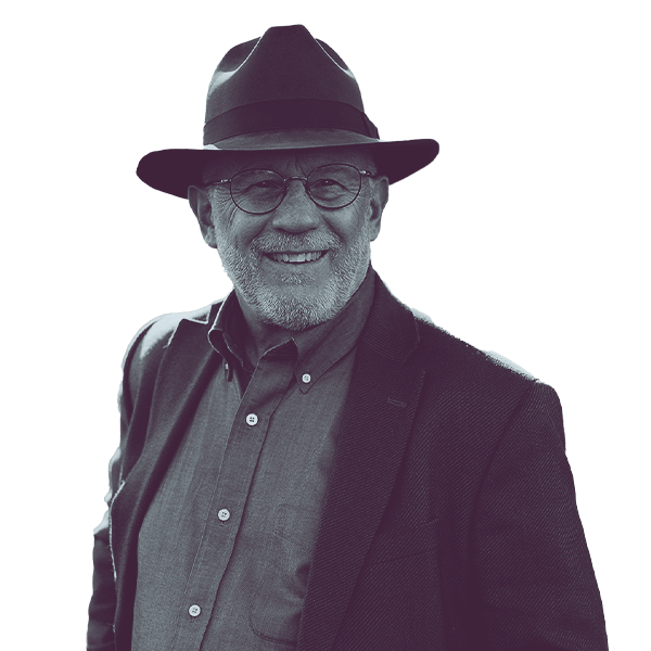 A black and white portrait of Mark Nicholson of Montana Senate District 24 from the waist up, smiling and looking into the camera.