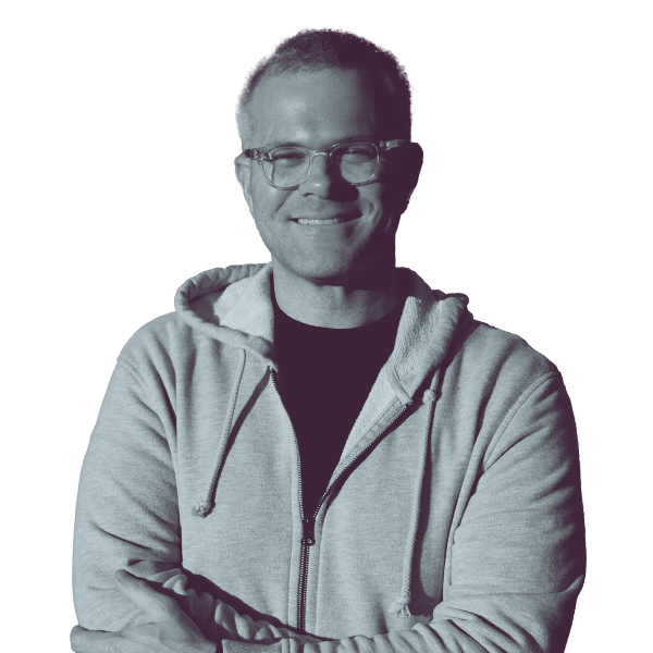 A black and white image of Ryan Hampton of Nevada Assembly district four from the waist up smiling and looking into the camera.