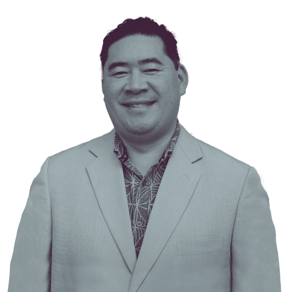 A black and white image of Jake Fitisemanu of Utah House district thirty from the waist up smiling and looking into the camera.