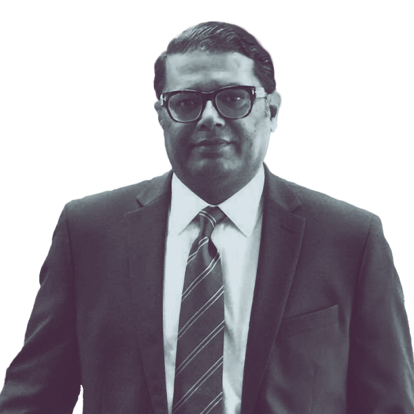 A black and white image of Farooq Mughal of Georgia House district one hundred and five from the waist up looking into the camera.