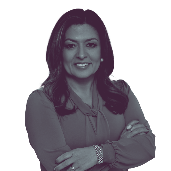 A black and white image of Laura Murvartian of Georgia House district forty-eight from the waist up smiling and looking into the camera.