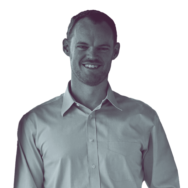 A black and white image of Kevin Volk of Arizona House district seventeen from the waist up, smiling and looking into the camera.