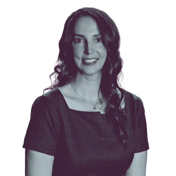 A black and white image of Aimee Bateman of Kansas House district forty-one from the waist up, smiling and looking into the camera.