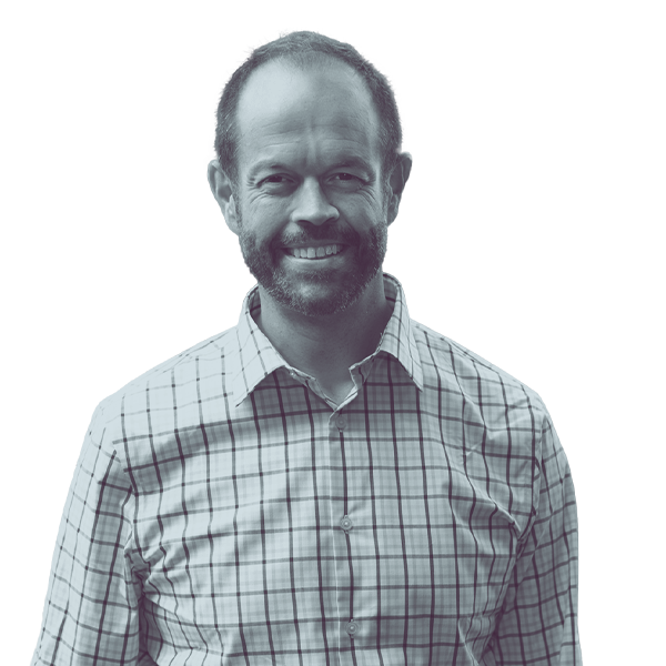 A black and white image of Andrew Mall of Kansas Senate district ten from the waist up, smiling and looking into the camera.