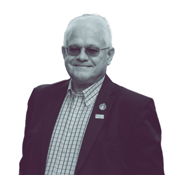A black and white waist-up portrait of Chuck Grassie, candidate for New Hampshire House District Strafford eight, smiling and looking into the camera.