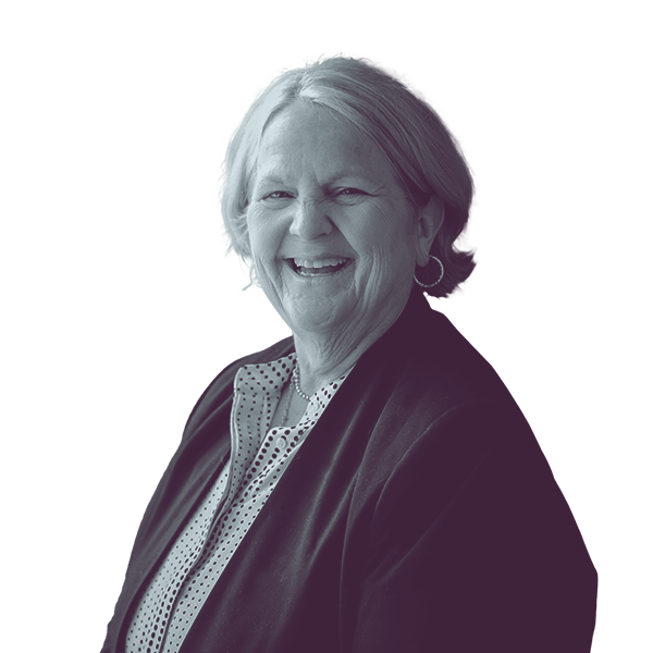 A black and white waist-up portrait of Judi Lanza, candidate for New Hampshire House District Hillsborough twenty nine, smiling and looking into the camera.