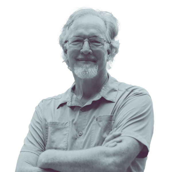 A black and white waist-up portrait of Scott Lawrence, candidate for New Hampshire House District Hillsborough forty three, smiling and looking into the camera.