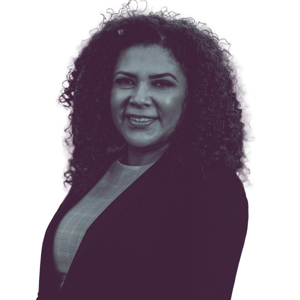 A black and white waist-up portrait of Ana Ruiz Kennedy, candidate for Washington House District fourteen, smiling and looking into the camera.