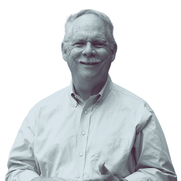 A black and white waist-up portrait of Tom Keen, candidate for Florida House District thirty five, smiling and looking into the camera.