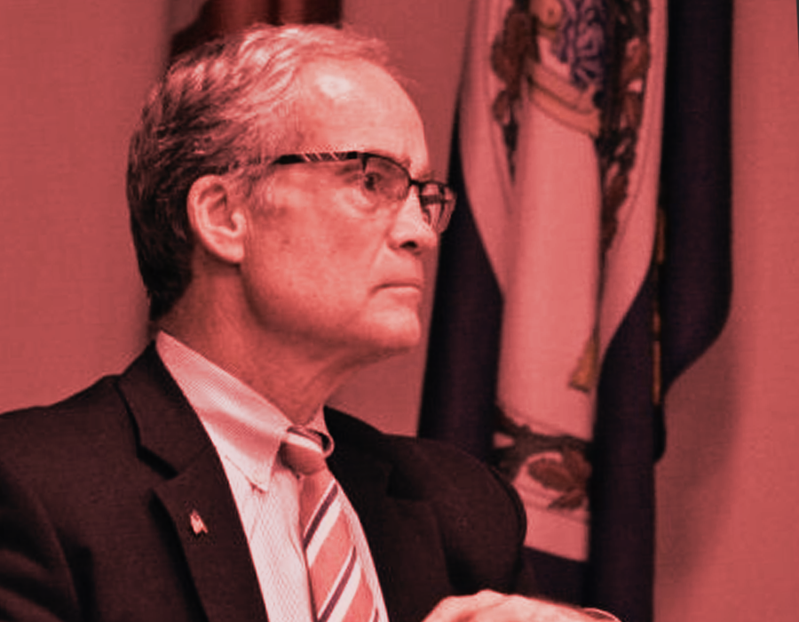 A portrait of Virginia MAGA extremist, Del. Geary Higgins. The image is in black and white with red overtones added.