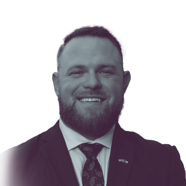 a black and white portrait of Taylor Rehmet, Democratic candidate for Texas Senate district 9, smiling and looking into the camera